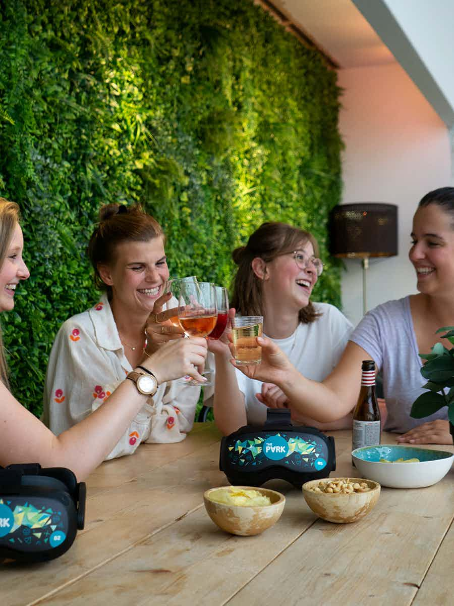 Group of women toasting glasses while laughing