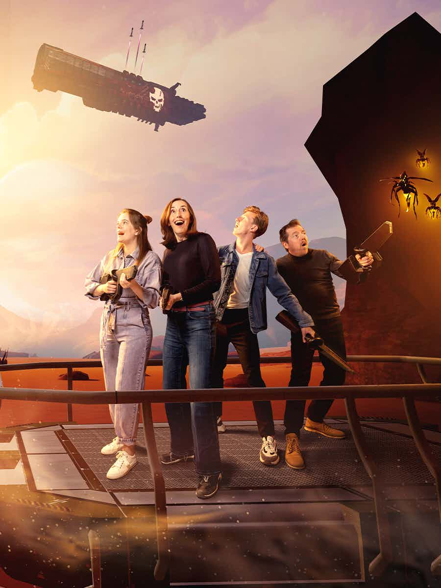 Shows a family of four on a platform in the desert of Planet X