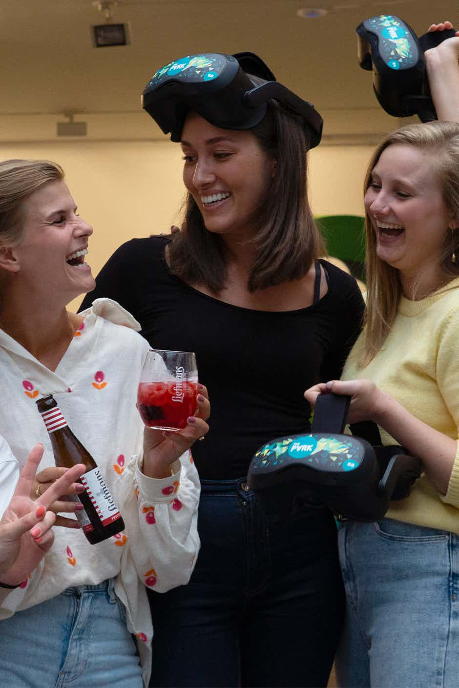 Group of women wearing vr goggles and drinking beer